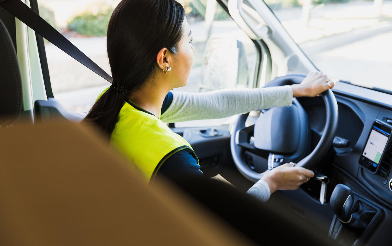 Photograph of a woman driving a car