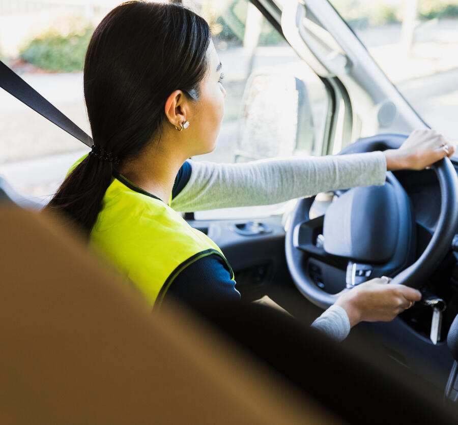 Photograph of a woman driving a car