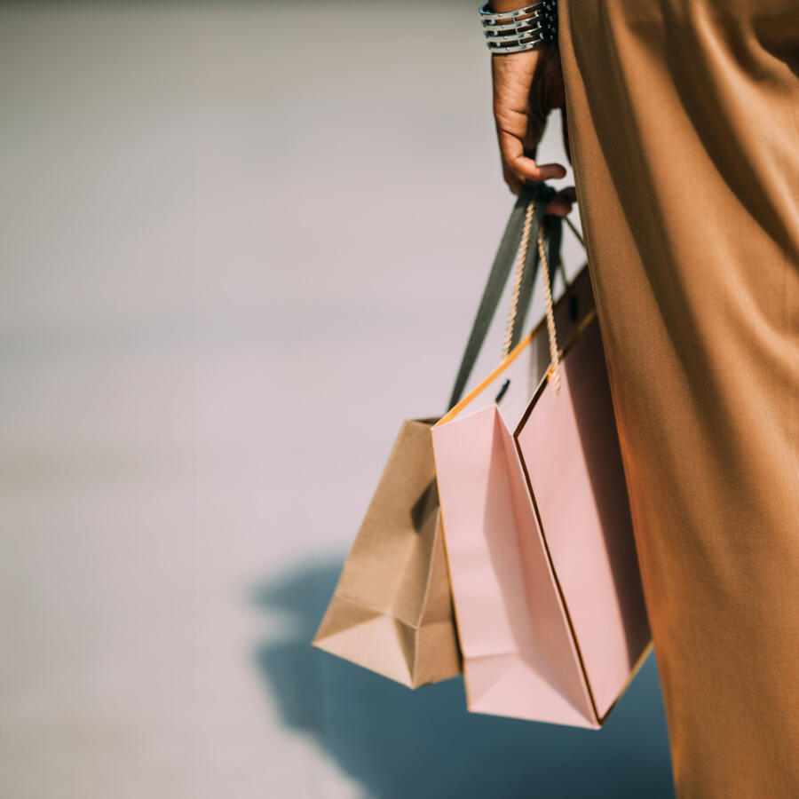 person holding carrier bags