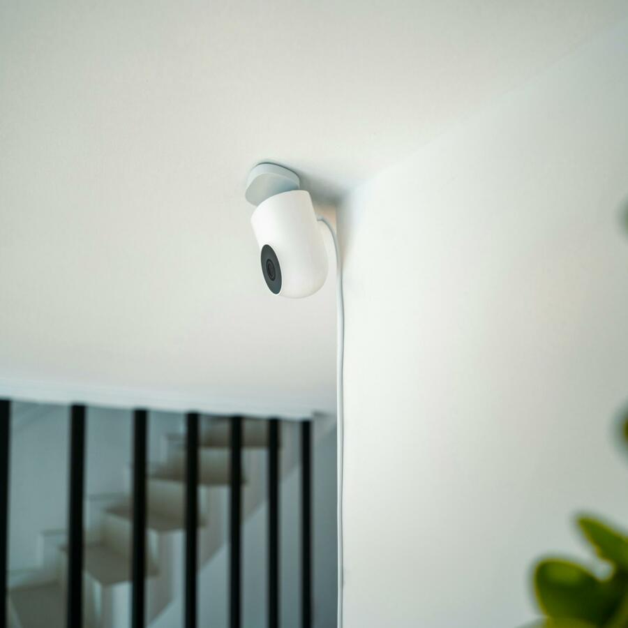 Photograph of a security camera mounted on a ceiling